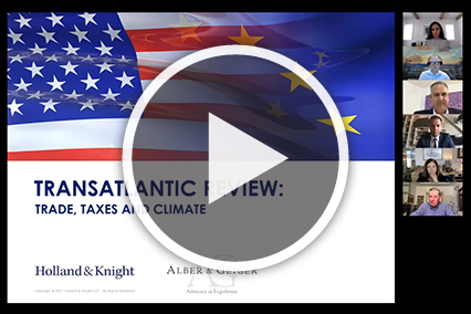 American flag and European Union flag with speakers headshots on Zoom